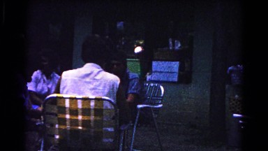 1963: various people including children sitting outside in lounge chairs