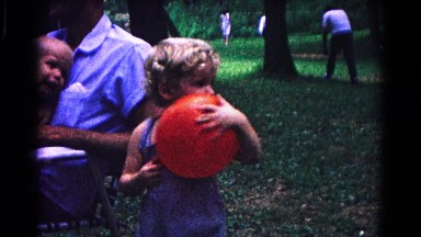 1963: a child holding her ball at the outside at the park COLD SPRINGS, NEW YORK