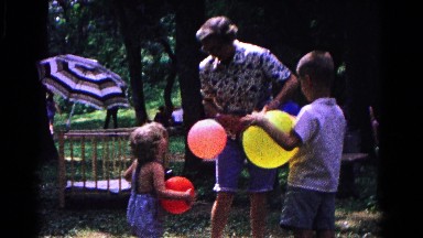 1963: older woman and children holding colorful balloons COLD SPRINGS, NEW YORK