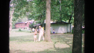 1963: a father with child is seen near a tree COLD SPRINGS, NEW YORK