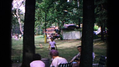 1963: a child walks through a small park between some trees. COLD SPRINGS