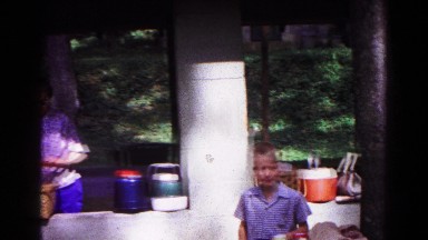 1963: women and children gather outside under a covered picnic area