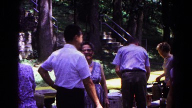 1963: attendees at an outdoor gathering hug and shake hands COLD SPRINGS