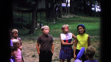 1963: boys and girls on a playground blowing bubble gum bubbles COLD SPRINGS