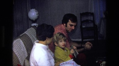 1975: Man, Woman, and Blonde Boy Sitting on Couch Talking