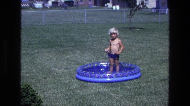 1975: boy standing in pool CALIFORNIA