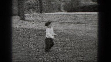 1948: happy kid with hat running through the ground in the park MIDDLETOWN