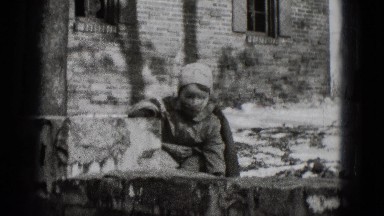 1948: a bundled child playing in the snow outside in the front yard MIDDLETOWN