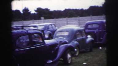 1955: Oldsmobiles Parked on Grassy Lot at Le Mans Grand Prix
