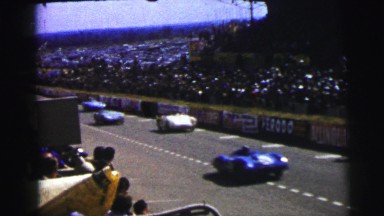 1955: Men Racing Cars Around a Race Track as People Watch Le Mans