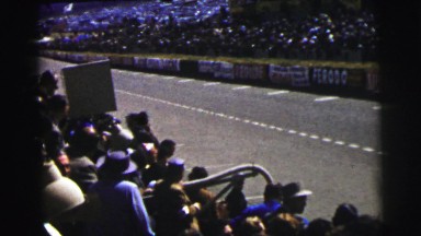 1955: race cars slowly pass by audience one by one in course lane LE MANS