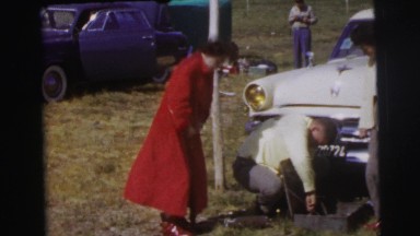 1955: two well dressed men and a woman appearing to be inflating a tire LE MANS