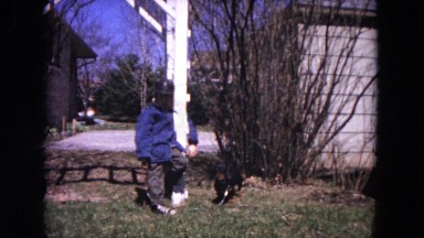 1964: A Small Boy and His Dachshund Standing Outdoors in a Snowy Yard, Evanston, Illinois