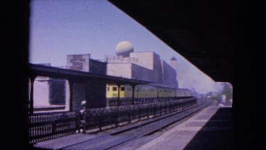 1964: train leaving station heading into big futuristic city EVANSTON, ILLINOIS