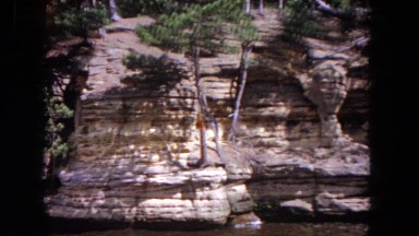 1964: a beautiful. rocky and rugged canyon wall along a body of water EVANSTON