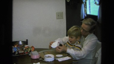 1975: mother son craft origami paper project on kitchen table CALIFORNIA