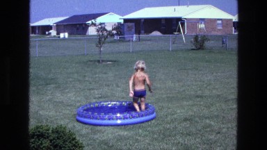 1975: a shirtless young child walking in circles around a kiddie pool CALIFORNIA