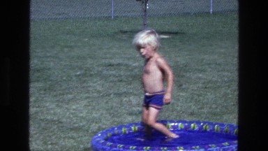 1975: Little Kid Playing in Backyard Pool California