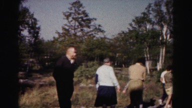 1962: people walking about what appears to be a historic site made of stone