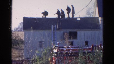 1968: vintage clip of firemen on the roof of the house