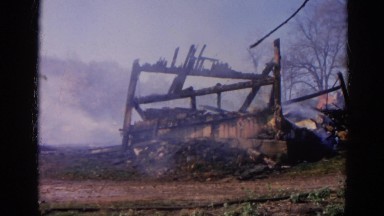 1968: firemen outside dressed in their uniforms walking on grass around