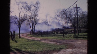 1968: a group of people looking on as a fire burns in the distance WAUCONDA