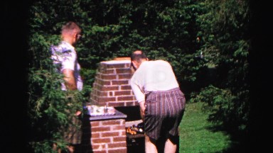 1962: a father and son outdoors grilling on the brick bbq pit HAGERSTOWN