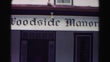 1962: three women and two men exit an establishment onto a porch with chairs