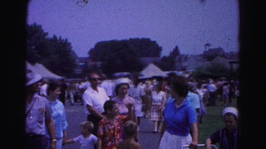 1962: people walking talking and enjoying the local fair with children