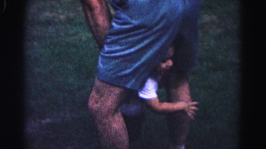 1962: male playing with child in grass HAGERSTOWN, MARYLAND
