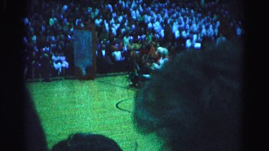 1962: people in costumes riding a go-kart across a basketball court