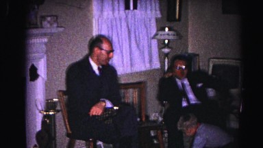 1962: family holiday event kids playing while adult men chat in chairs