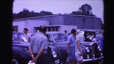 1962: various people walking down along the hoods of parked cars HAGERSTOWN