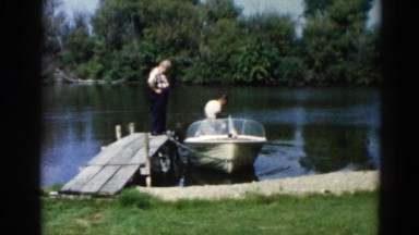 1962: man fixes a boat while others watch CHICAGOLAND AREA