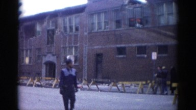 1962: a drive through a city street where a large building has been damaged