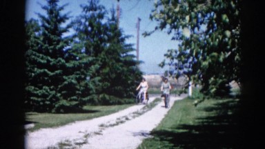 1962: Two Women Biking Through Shaded Trees in Chicagoland Area