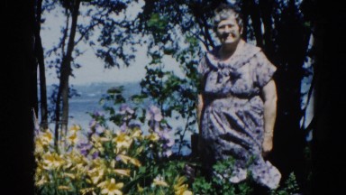 1962: grandma enjoys a beautiful spring day with a breeze near the shore.