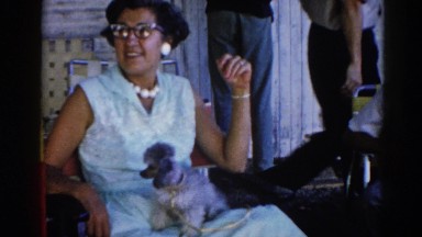 1962: mother and little best friend pet enjoying their day in front of the house