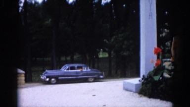 1962: the man watching an old lady from car when she is in the garden