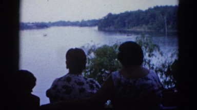 1962: family watching water skier at a relaxing lake vacation destination