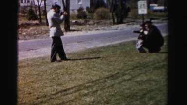 1956: Father and Funny Kid Posing for a Photograph Taken by a Man