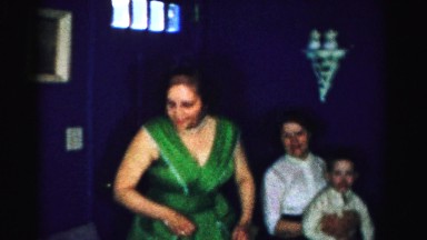 1956: woman in party dress scratches head MADISON, WISCONSIN