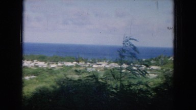 1964: weather on an island as the wind picks up a family hangs clothes to dry.