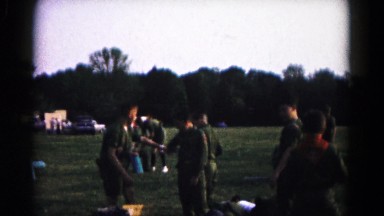 1966: boy scout sharing drink with boy scout prepping for camping trip