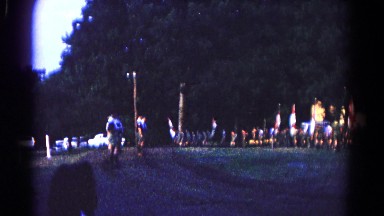 1966: people in various costumes marching through the street in a parade