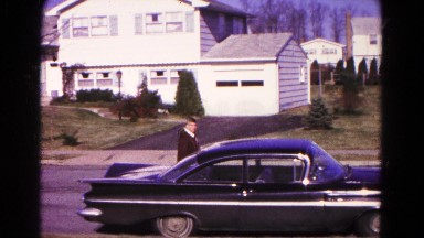 1966: he walk to open car door located at road put a briefcase behind seat