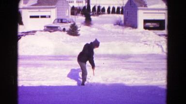 1966: man wearing a hoodie that is shoveling snow in the light wind HAGERSTOWN