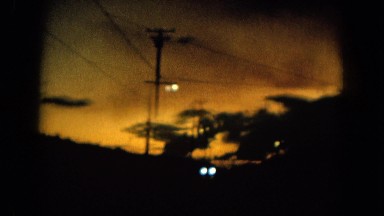 1964: after a drive at sundown, two girls play with their pretty pet blue bird