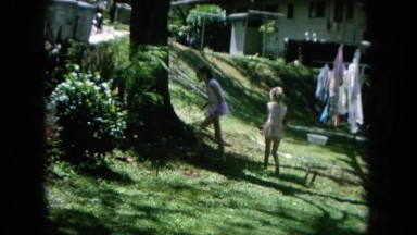 1964: two girls in the backyard looking for the cat around the laundry HAWAII