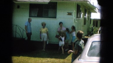 1964: woman modeling an eccentric hat with a blue lace in a summer day HAWAII